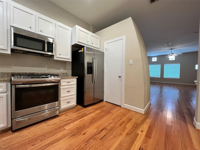 kitchen with white cabinetry, ceiling fan, light stone counters, light hardwood / wood-style floors, and appliances with stainless steel finishes