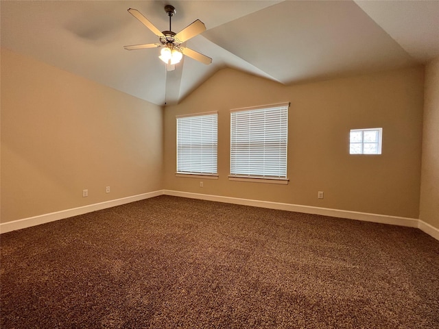 carpeted empty room featuring vaulted ceiling and ceiling fan