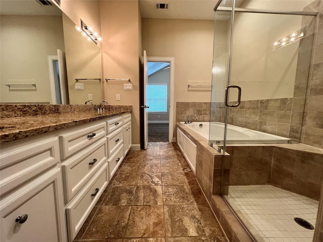 bathroom with vanity and independent shower and bath