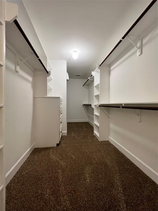 spacious closet with dark carpet