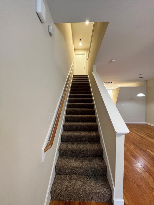 staircase featuring hardwood / wood-style floors