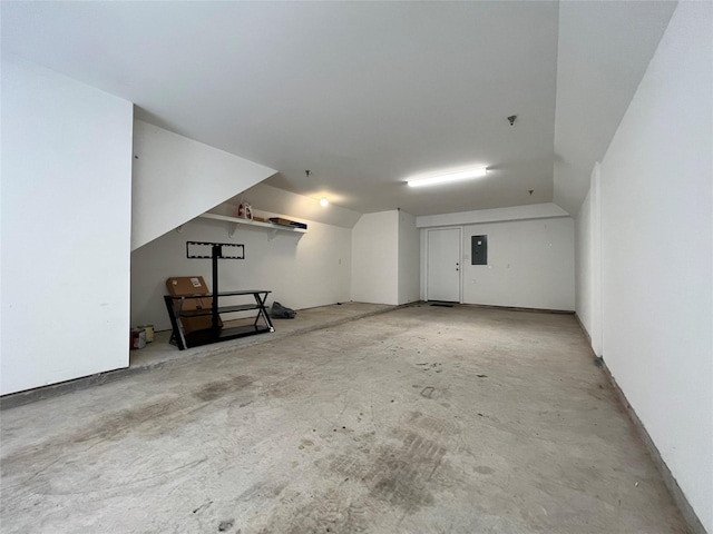 bonus room featuring lofted ceiling, concrete flooring, and electric panel