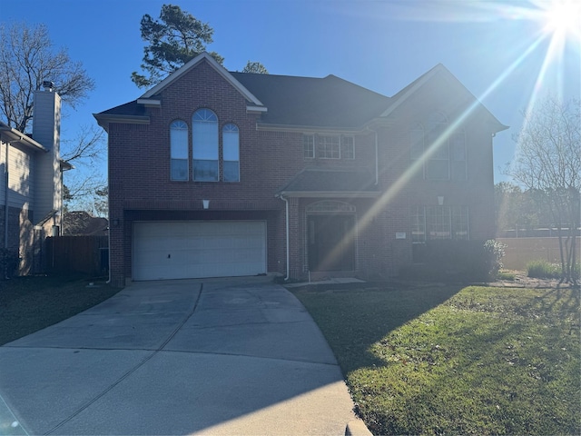 front of property featuring a front yard and a garage