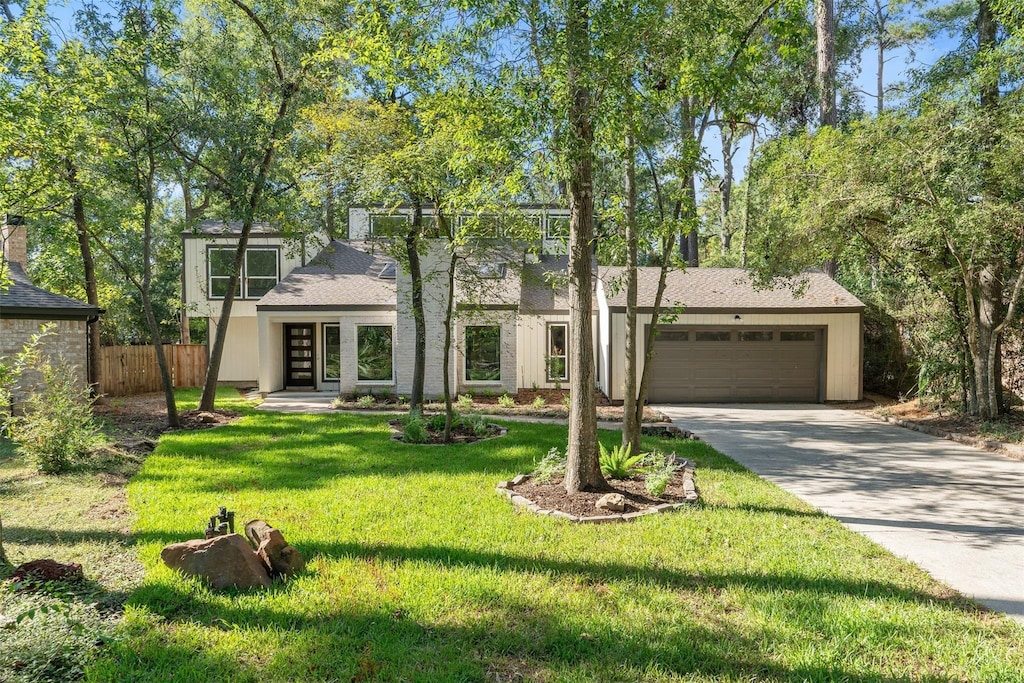 view of front of house with a front yard and a garage