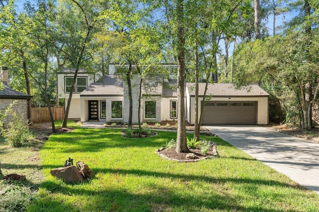 view of front of house with a front yard and a garage