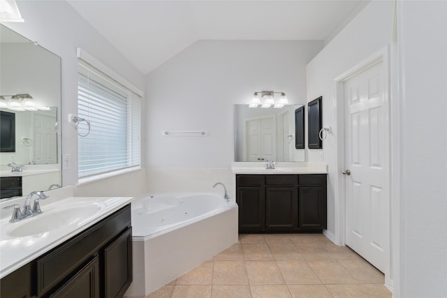 bathroom with lofted ceiling, tiled bath, tile patterned flooring, and vanity