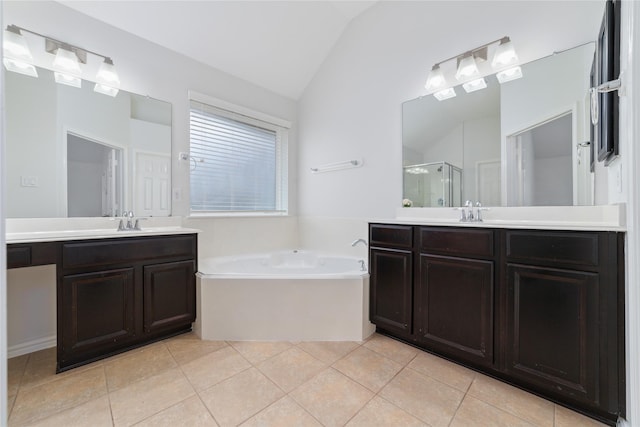 bathroom featuring independent shower and bath, vanity, lofted ceiling, and tile patterned floors