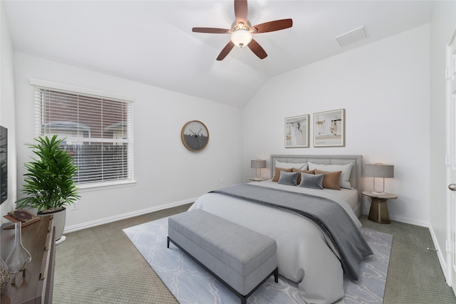 bedroom with ceiling fan, lofted ceiling, and dark colored carpet