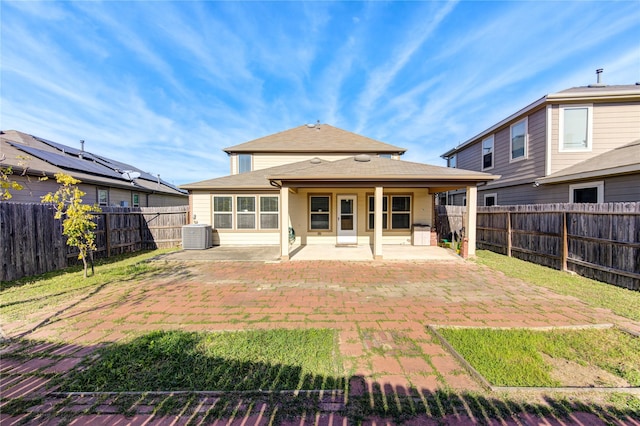 back of house featuring central AC unit and a patio area