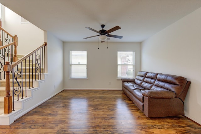 living room featuring ceiling fan and dark hardwood / wood-style flooring