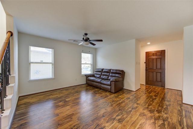 living room with ceiling fan and dark hardwood / wood-style flooring