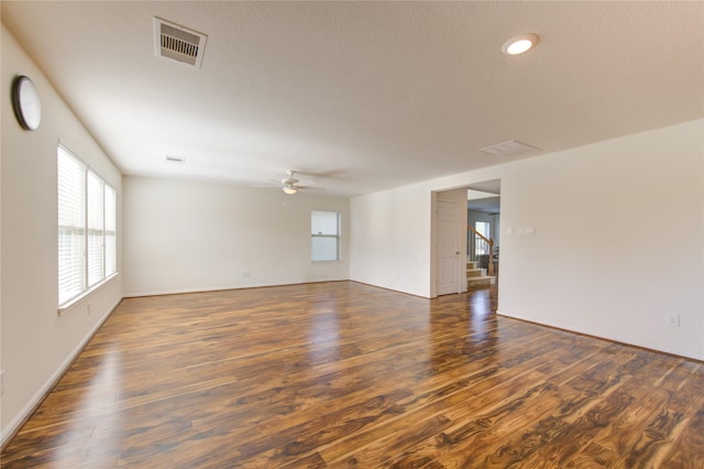 empty room featuring dark hardwood / wood-style flooring and ceiling fan