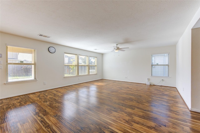 spare room featuring a textured ceiling, dark hardwood / wood-style flooring, and ceiling fan