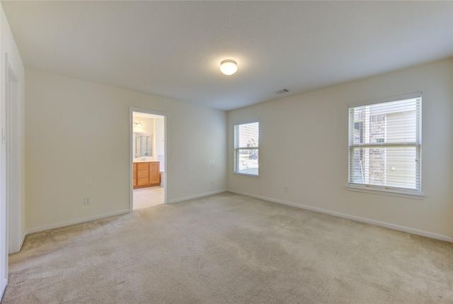 carpeted empty room with a wealth of natural light