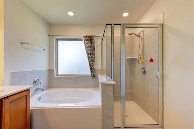 bathroom featuring vanity and shower with separate bathtub