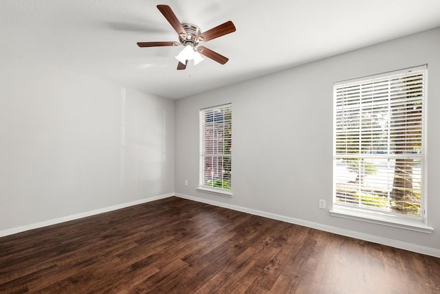 empty room featuring ceiling fan and dark wood-type flooring