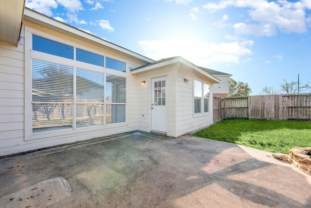 rear view of property featuring a lawn and a patio