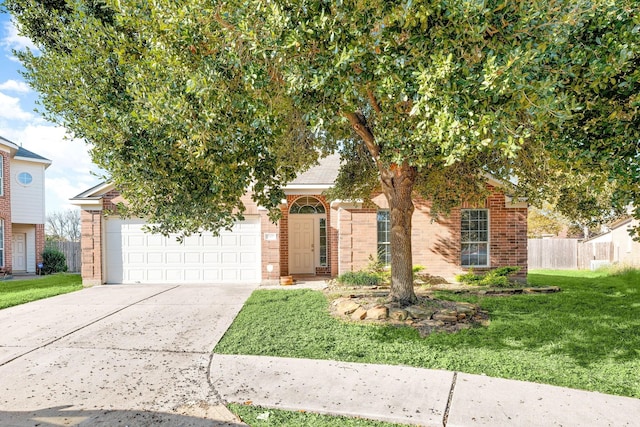 view of property hidden behind natural elements featuring a front lawn and a garage