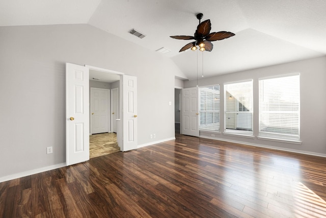 spare room featuring dark hardwood / wood-style flooring, vaulted ceiling, and ceiling fan