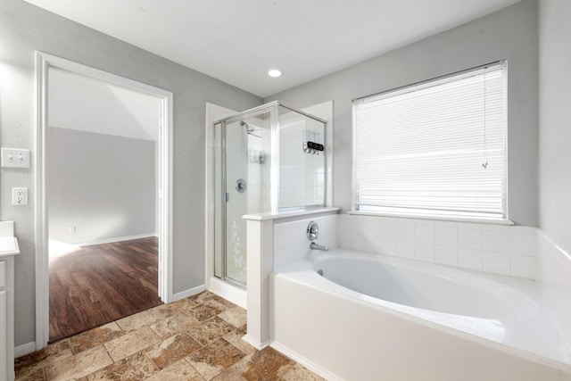 bathroom featuring vanity and plus walk in shower