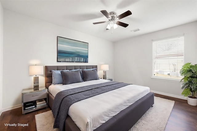 bedroom with ceiling fan and dark hardwood / wood-style flooring