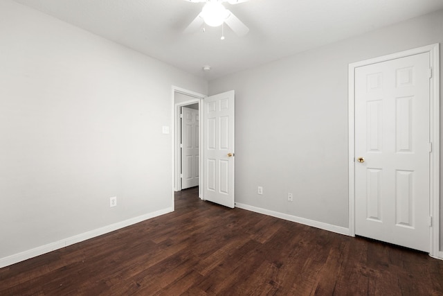 unfurnished bedroom featuring dark hardwood / wood-style flooring and ceiling fan