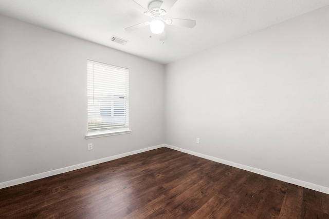 spare room featuring ceiling fan and dark wood-type flooring