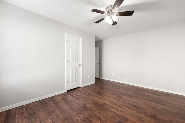 empty room featuring ceiling fan and dark hardwood / wood-style floors