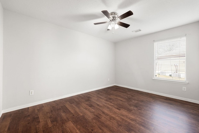 empty room featuring dark hardwood / wood-style floors and ceiling fan