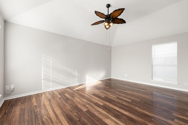 empty room with ceiling fan, dark wood-type flooring, and vaulted ceiling