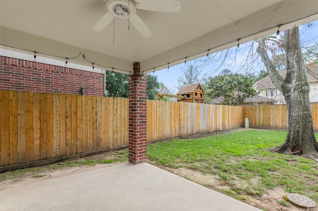 view of yard featuring ceiling fan and a patio area