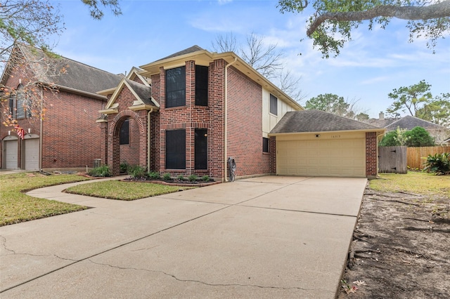 view of front facade featuring concrete driveway, an attached garage, fence, a front lawn, and brick siding