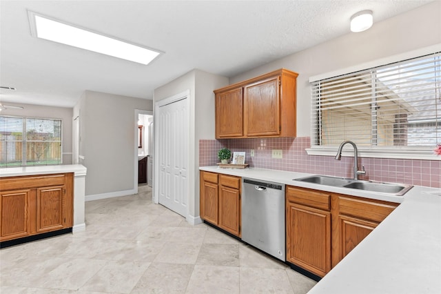 kitchen featuring dishwasher, tasteful backsplash, ceiling fan, and sink