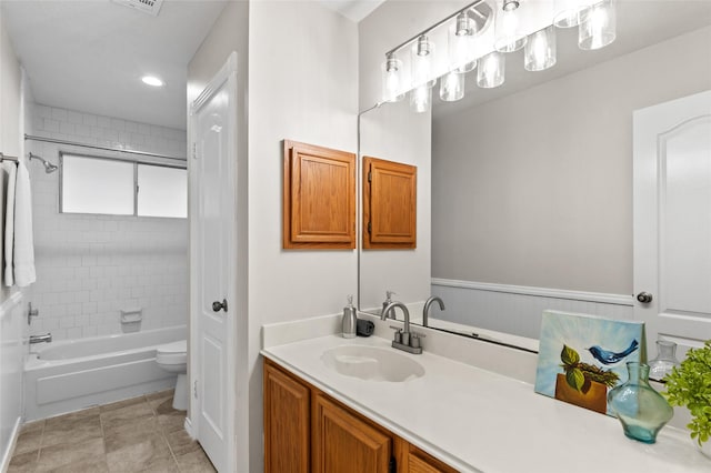 full bathroom featuring vanity, toilet, and tiled shower / bath combo