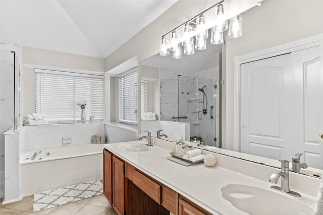 bathroom with tile patterned flooring, vanity, vaulted ceiling, and independent shower and bath