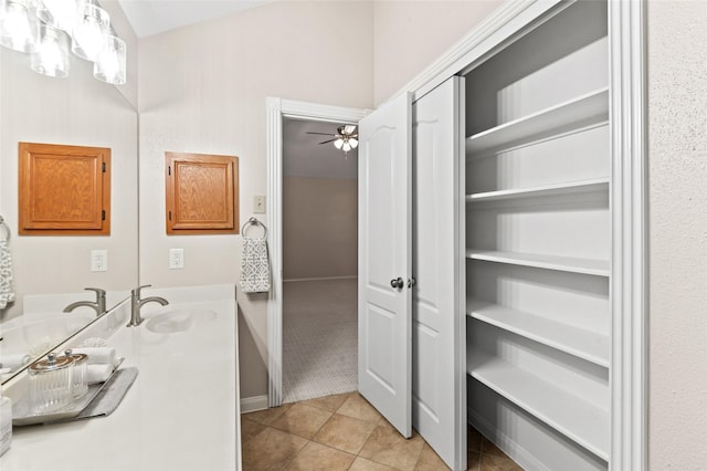 bathroom featuring tile patterned flooring, vanity, and ceiling fan