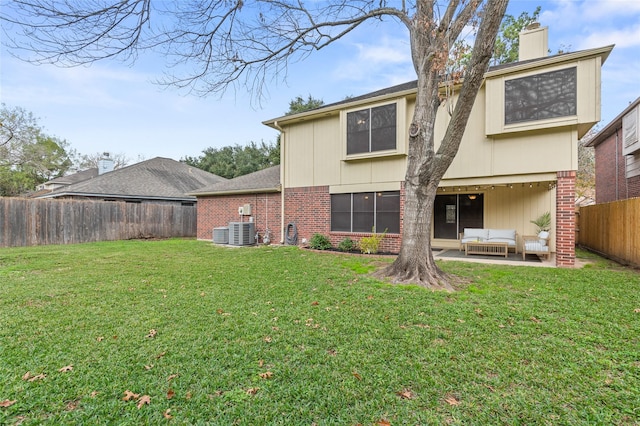 rear view of house with a yard, an outdoor hangout area, and central air condition unit