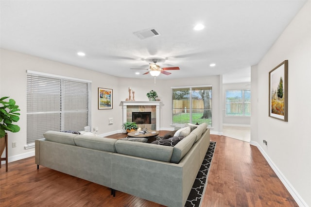 living room with a fireplace, hardwood / wood-style flooring, and ceiling fan