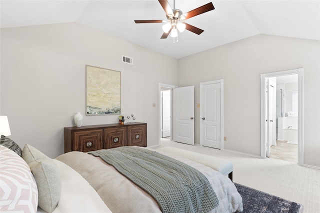 carpeted bedroom with connected bathroom, vaulted ceiling, and ceiling fan