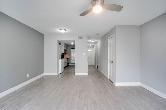 unfurnished living room featuring ceiling fan and light wood-type flooring