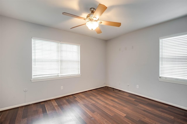 spare room with dark hardwood / wood-style floors and ceiling fan