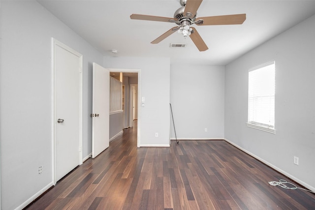 unfurnished bedroom featuring ceiling fan and dark hardwood / wood-style floors