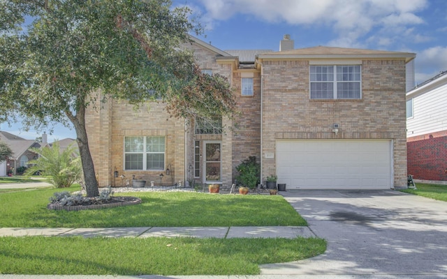 view of front of home featuring a garage and a front yard