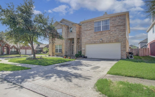 view of front of property with a garage and a front lawn