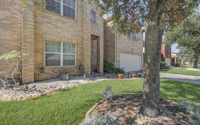 view of front of property featuring a garage and a front lawn