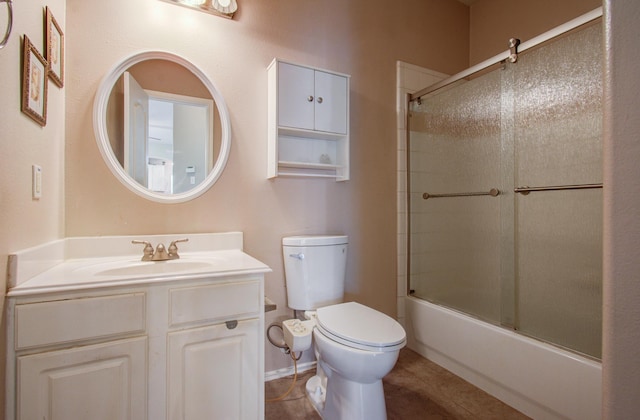 full bathroom featuring tile patterned floors, vanity, bath / shower combo with glass door, and toilet