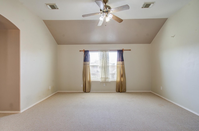 carpeted spare room with vaulted ceiling and ceiling fan