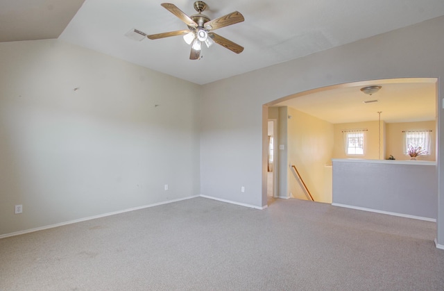 carpeted spare room with ceiling fan