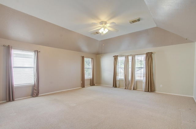 carpeted spare room featuring ceiling fan and lofted ceiling