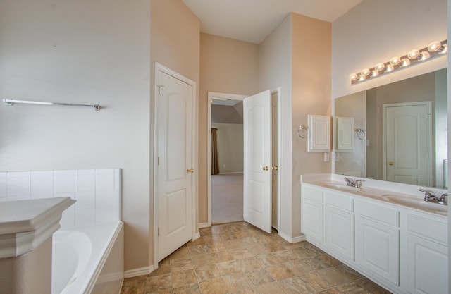 bathroom with vanity and a bath